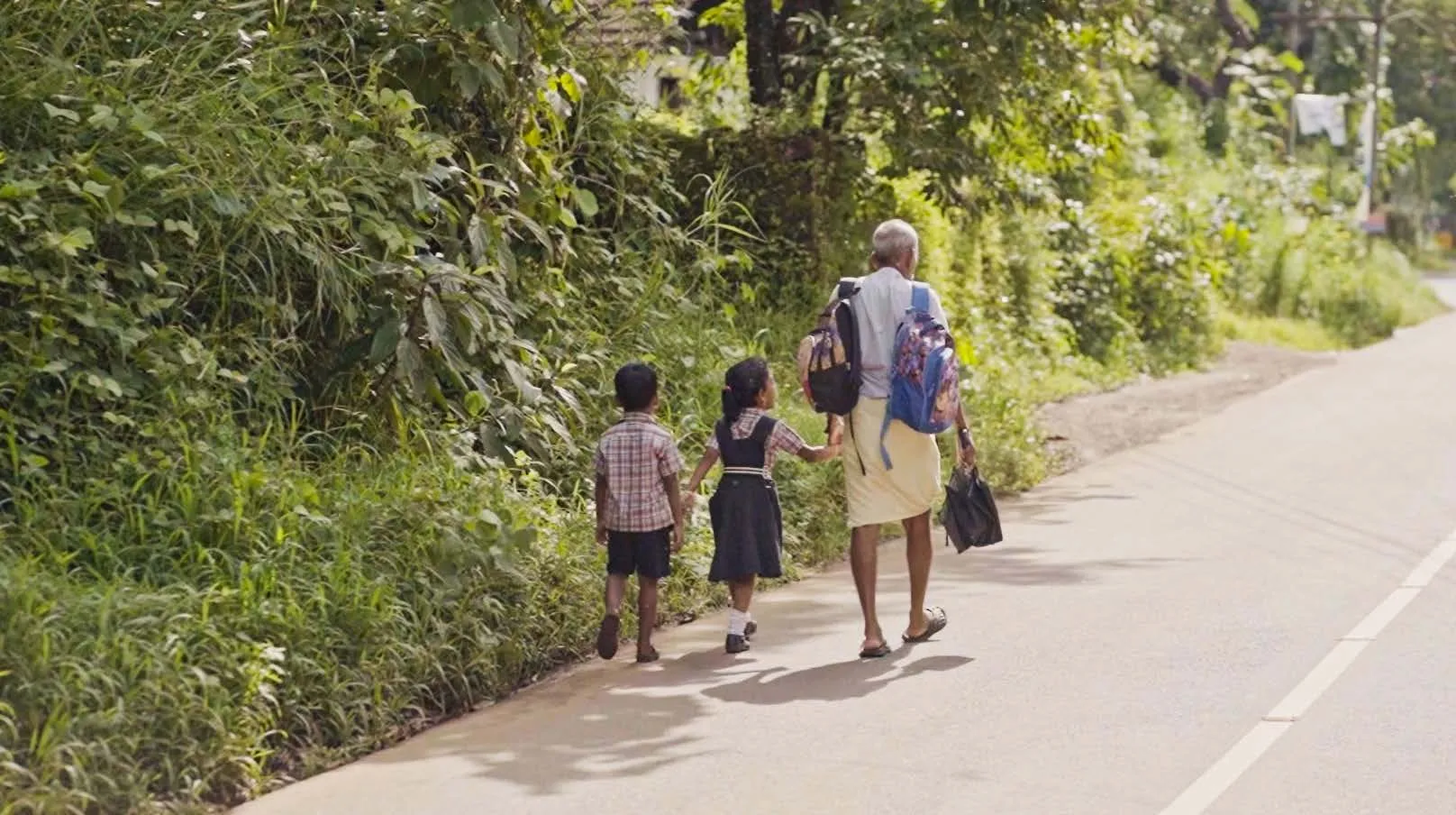 Guy and 2 children walking